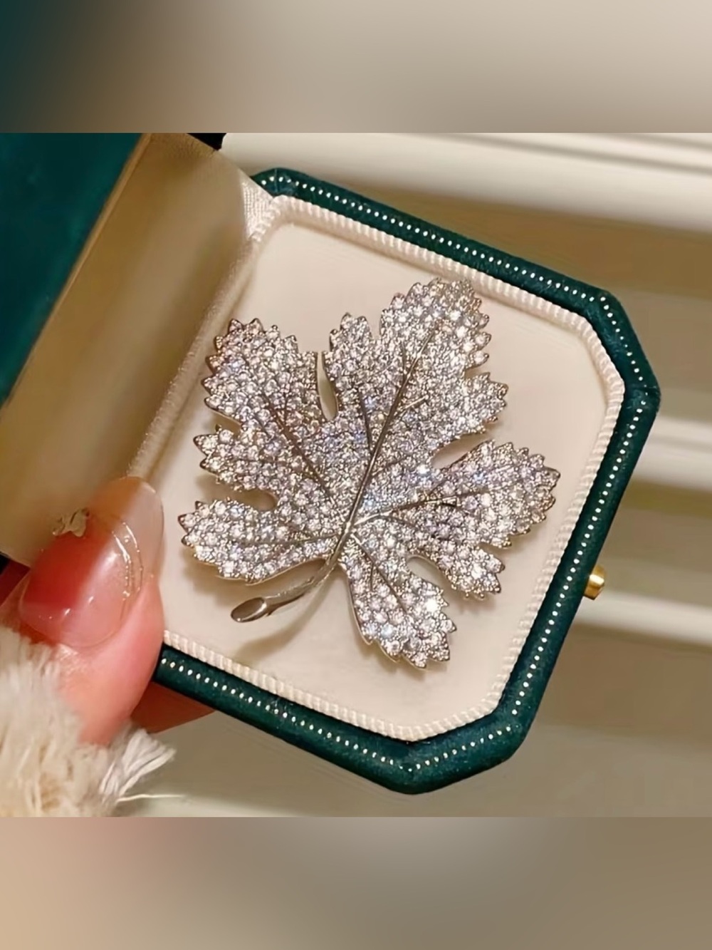 Sparkling silver-tone maple leaf brooches featuring pavé-set clear rhinestones.